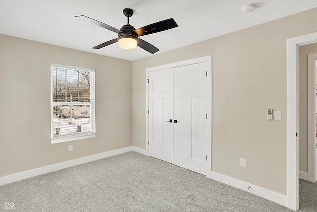 unfurnished bedroom featuring a closet, ceiling fan, and carpet flooring