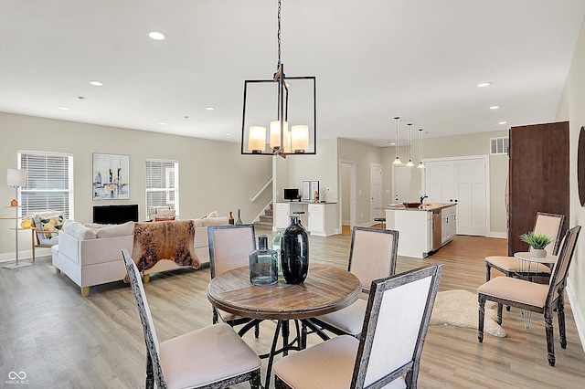 dining area featuring sink and light wood-type flooring