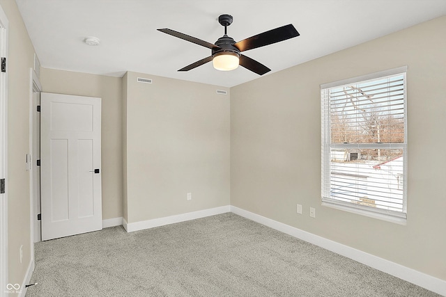 carpeted empty room featuring ceiling fan