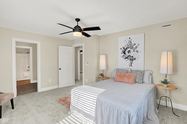 bedroom with light carpet, ceiling fan, and ensuite bathroom