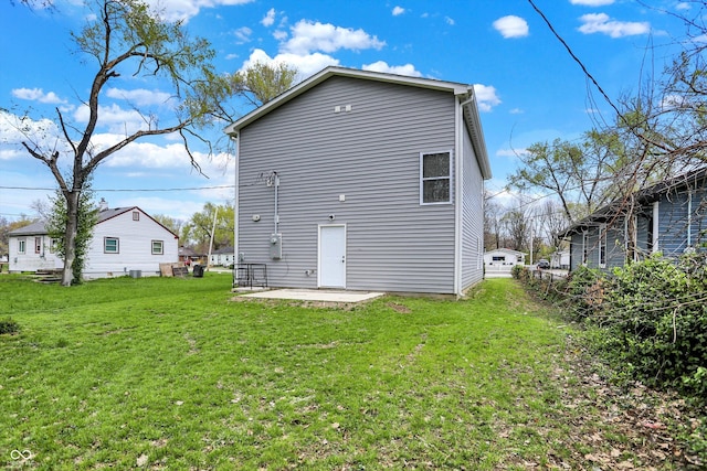 3264 Orchard Ave, Indianapolis, IN 46218 - rear view of house with a yard and a patio area