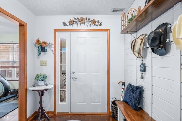 entryway with a textured ceiling