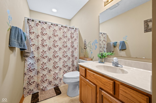 bathroom with vanity, curtained shower, and toilet