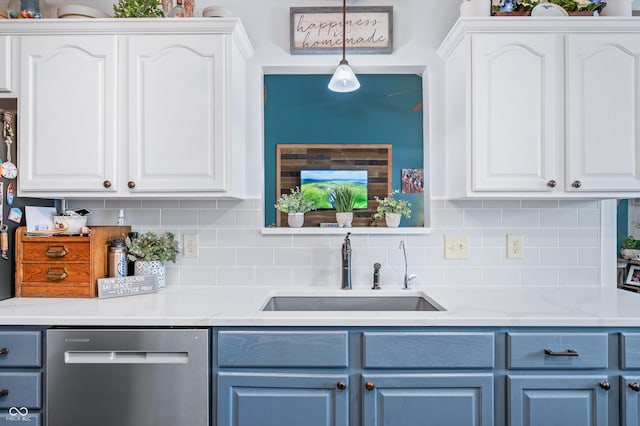 kitchen with pendant lighting, sink, and white cabinets