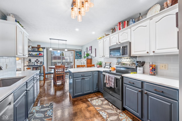 kitchen featuring white cabinetry, decorative light fixtures, stainless steel appliances, and gray cabinetry