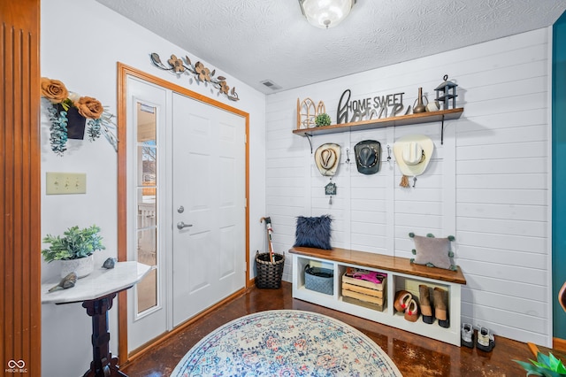 mudroom featuring a textured ceiling