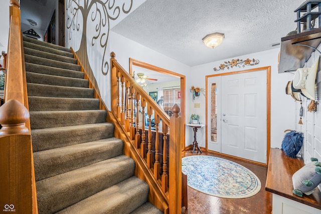 entryway featuring a textured ceiling