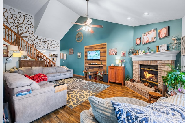 living room with a fireplace, high vaulted ceiling, dark hardwood / wood-style floors, and ceiling fan