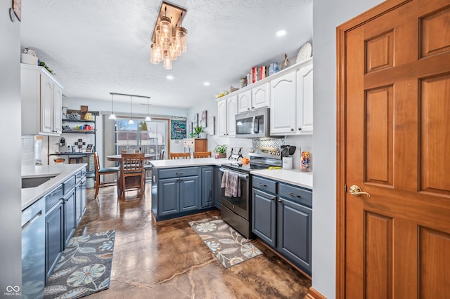 kitchen with gray cabinetry, white cabinetry, decorative light fixtures, kitchen peninsula, and stainless steel appliances