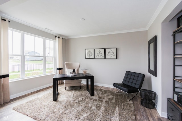 home office with ornamental molding and hardwood / wood-style floors