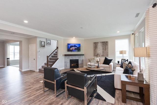 living room with ornamental molding and hardwood / wood-style floors