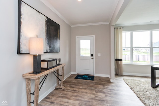 entryway with hardwood / wood-style flooring, ornamental molding, and a healthy amount of sunlight