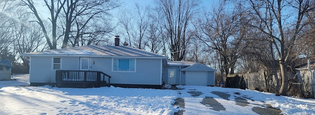 view of front of home featuring a garage and an outbuilding