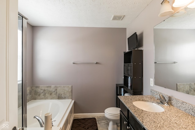 bathroom with toilet, vanity, a bath, and a textured ceiling