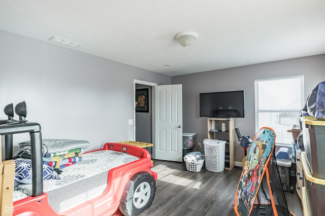 bedroom with dark hardwood / wood-style floors