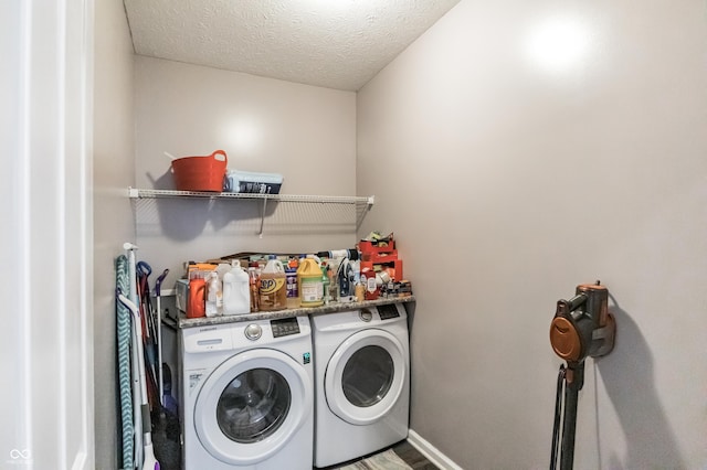 laundry area with a textured ceiling and independent washer and dryer