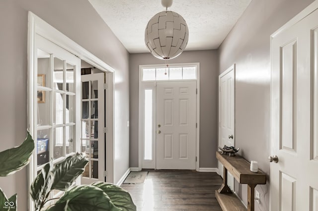 entrance foyer featuring dark hardwood / wood-style flooring and a textured ceiling