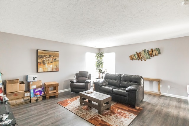 living room featuring dark hardwood / wood-style floors and a textured ceiling