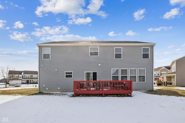 snow covered property featuring a deck