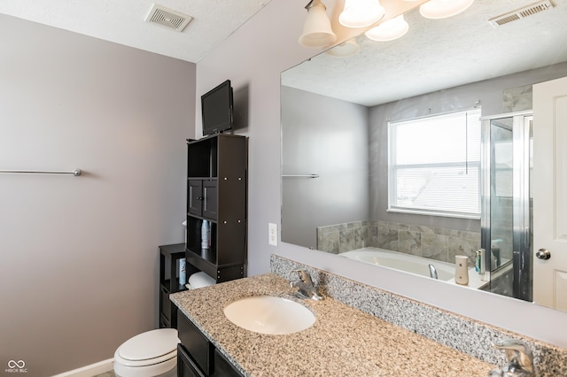 full bathroom with vanity, toilet, independent shower and bath, and a textured ceiling