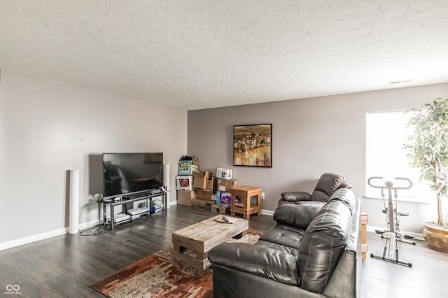 living room with dark hardwood / wood-style flooring and a textured ceiling