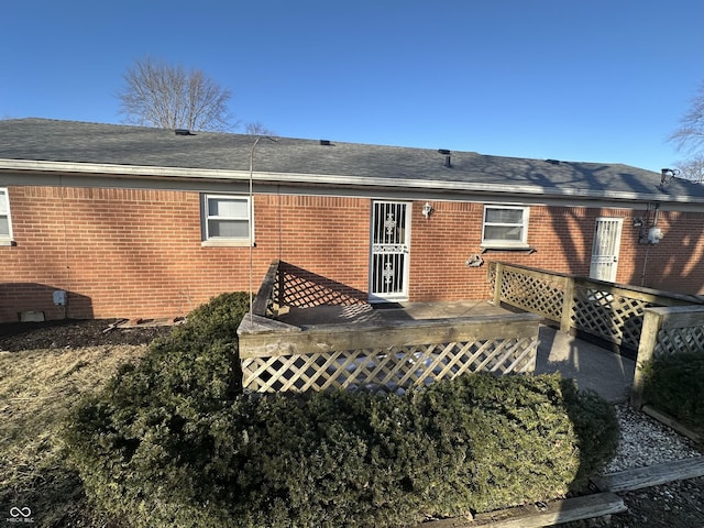 rear view of house featuring a wooden deck