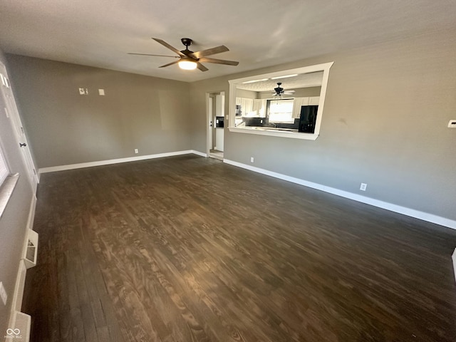 spare room with dark wood-type flooring and ceiling fan