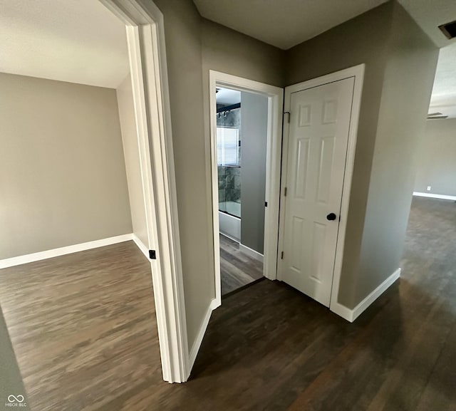 hall with dark hardwood / wood-style flooring