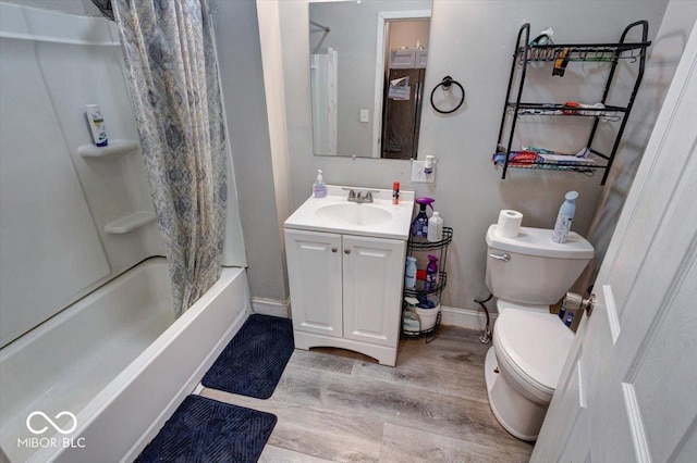 full bathroom featuring shower / tub combo, vanity, hardwood / wood-style flooring, and toilet