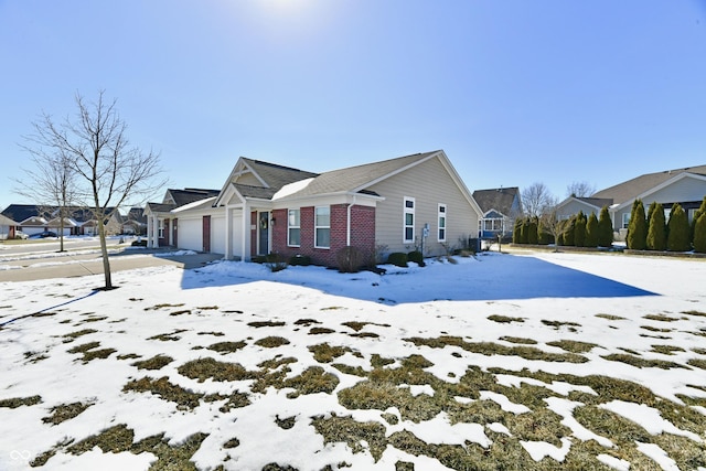 view of snowy exterior featuring a garage