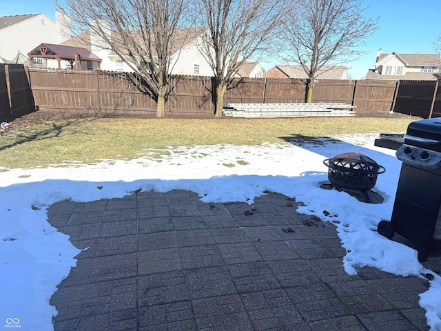 snowy yard with a fire pit