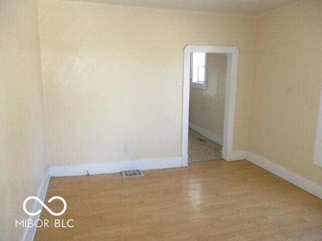 spare room featuring light hardwood / wood-style floors