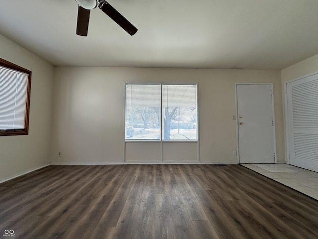 unfurnished room featuring ceiling fan and dark hardwood / wood-style flooring