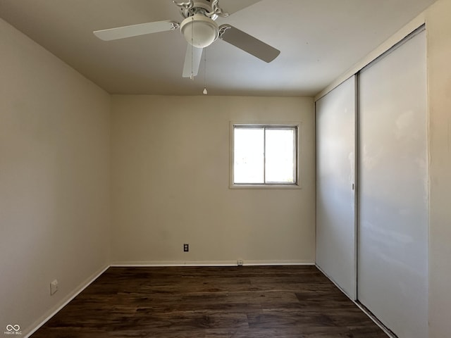 spare room with ceiling fan and dark hardwood / wood-style flooring