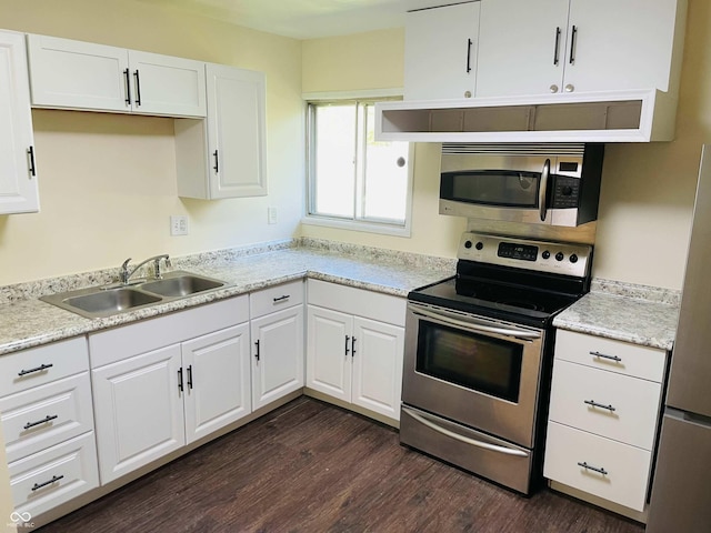 kitchen with sink, dark wood-type flooring, stainless steel appliances, and white cabinets