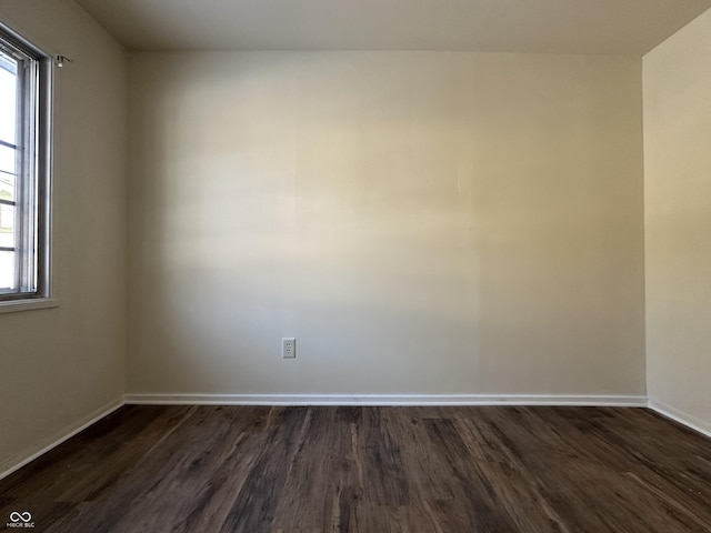 empty room with dark wood-type flooring