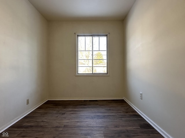 spare room with dark hardwood / wood-style flooring