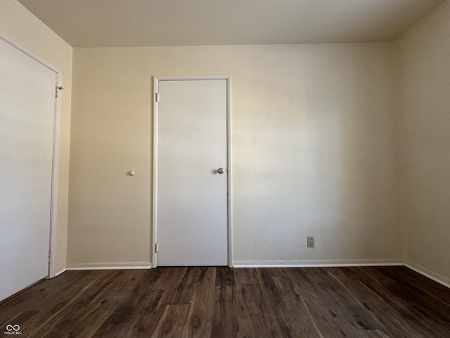 unfurnished bedroom with dark hardwood / wood-style floors