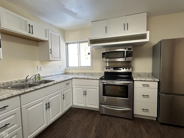 kitchen with white cabinetry, sink, dark wood-type flooring, and appliances with stainless steel finishes