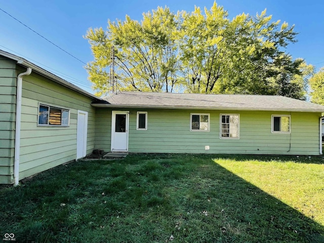 back of property featuring a lawn