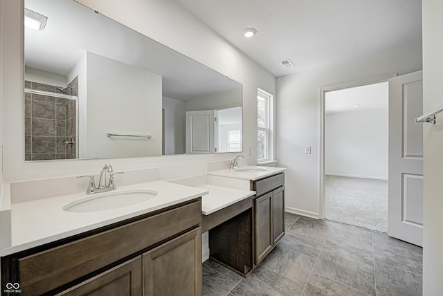 full bath featuring double vanity, a sink, and visible vents