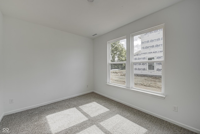 carpeted spare room with baseboards