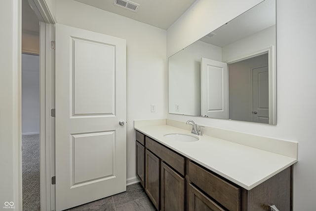 bathroom featuring baseboards, visible vents, and vanity