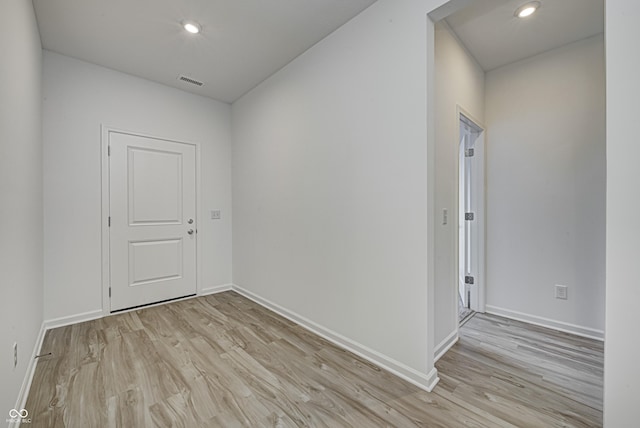 empty room with light wood-type flooring, visible vents, and recessed lighting