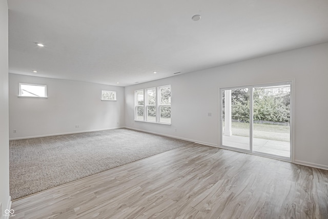 unfurnished room featuring plenty of natural light, baseboards, and recessed lighting