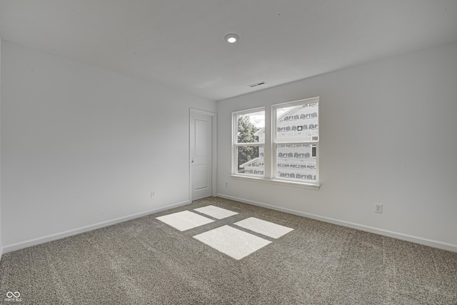 empty room with recessed lighting, carpet, visible vents, and baseboards