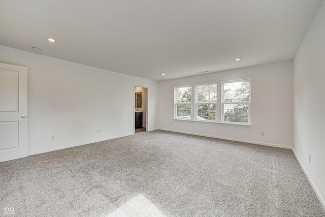 empty room with recessed lighting, carpet flooring, visible vents, and baseboards