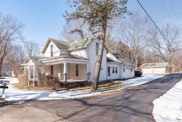 view of front of property with an outbuilding, a garage, and a porch