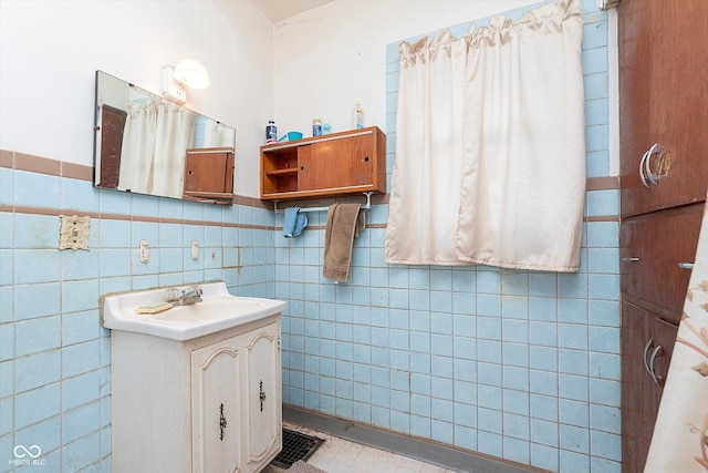 bathroom with vanity and tile walls