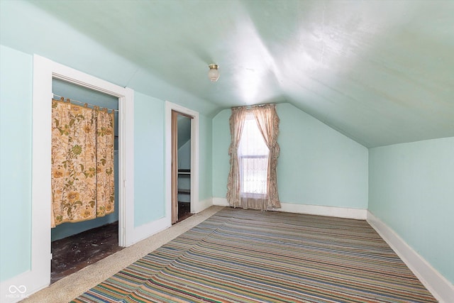 additional living space featuring lofted ceiling